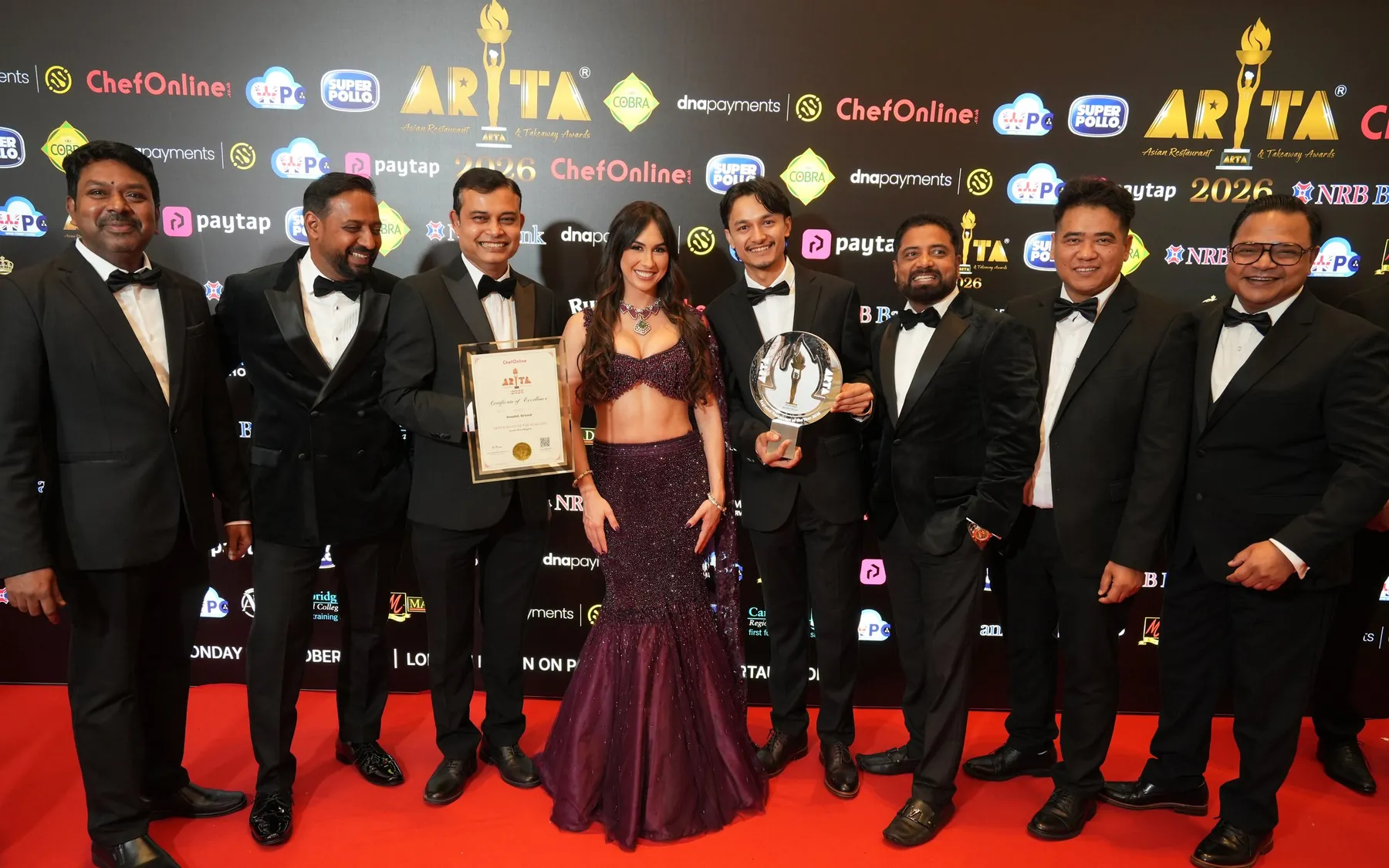 The Bombil team on the red carpet at the ARTA 2026 grand finale, holding the trophy and the certificate