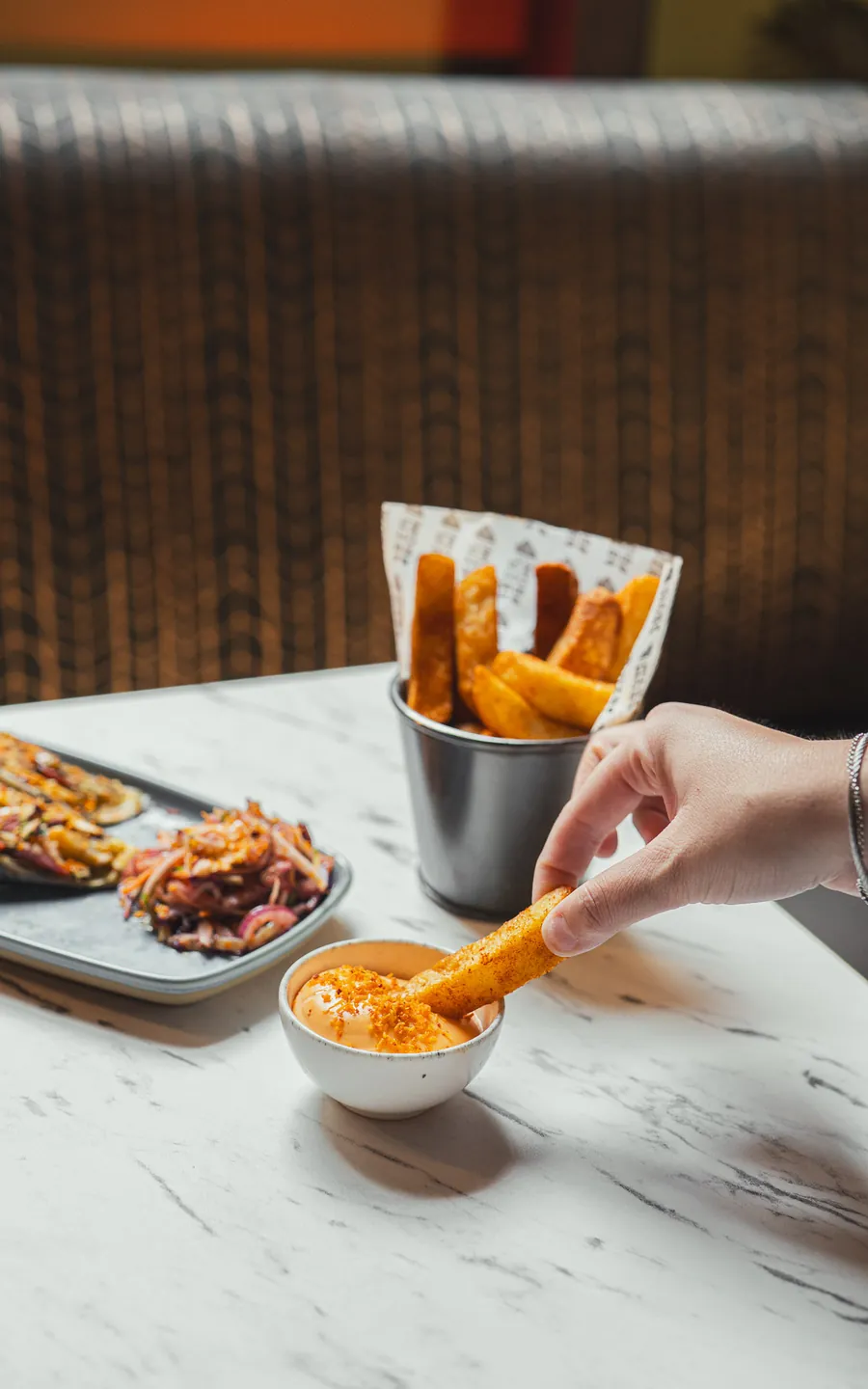 A Bombil chip dunked into a spiced dip