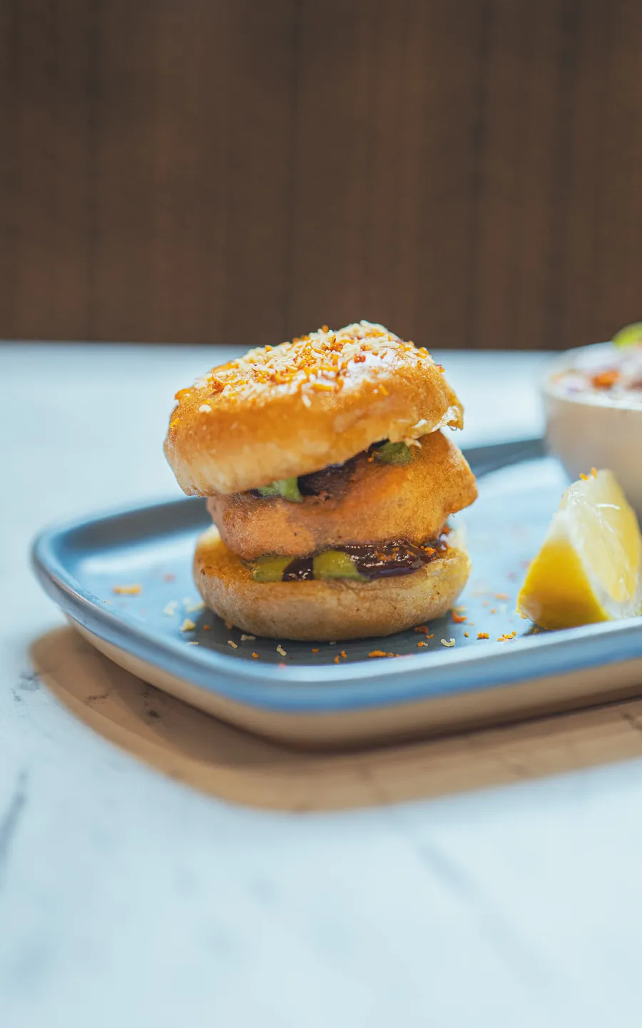 Vada pav: a spiced potato fritter in a soft bun, with lemon