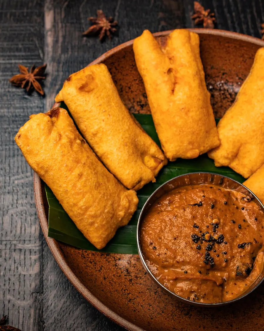Golden fried snacks with a spiced dip at Nadu